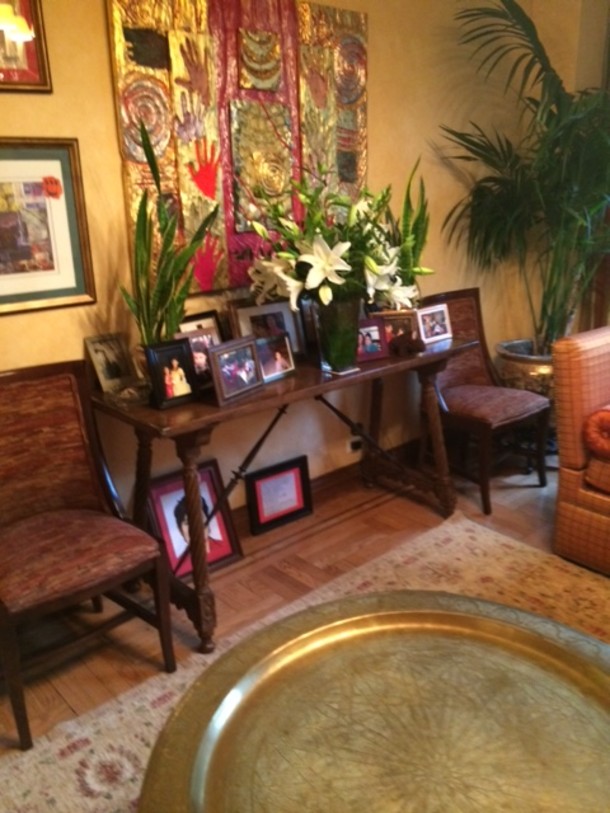 In the living room, flowers and family photographs under Nancy Azara’s amazing wall panel sculpture, which I adore.