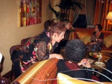 Phyllis talks to Na’ama Sandrow. Nidra Poller, on couch, talks to Norma Rosen.